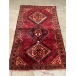An eastern red ground rug. 81' x 51'