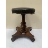 A William IV rosewood piano stool on quadripartite base with volute feet. Loss to seat moulding