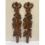 A pair of 19th century French pine wall appliques, carved with foliage with ribbon-tie surmounts.