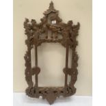 An oak looking glass frame carved in chinoiserie style. 38' high.