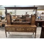 A George III oak and mahogany crossbanded dresser, the raised open rack with cupboards and spice