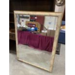 A modern wall mirror with bevelled plate. 54' x 40'