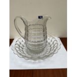 A 19th century cut glass jug and bowl of large size, the shaped baluster jug with a swept handle.