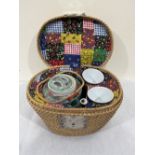 A Chinese teapot and a pair of tea bowls in basket weave case