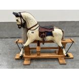 A composition rocking horse on trestle stand, manufactured by Haddon Rockers, Wallingford. 48'