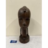 An African carved lignum tribal head. 7¾' high