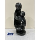 A carved stone group, mother and child, in the manner of Sir Henry Moore. 8¼' high