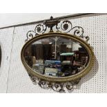 A 19th century Adam revival oval looking glass, with bevelled plate, the frame with wired gesso