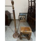 A lamp standard carved with foliage in chinoiserie style and a nest of three occasional tables