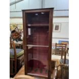 A mahogany gun cabinet enclosed by a glazed door. 51' high x 21¼' wide