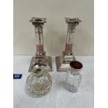 A pair of plated corinthian candlesticks 7¼' high and two silver topped dressing table jars