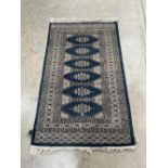 A blue ground eastern style rug. 59' x 36'
