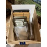 A box of small frames, mounts etc.