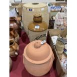 A stoneware barrel, an earthenware storage jar and cover and a 2 gallon brewer's jar. (3)