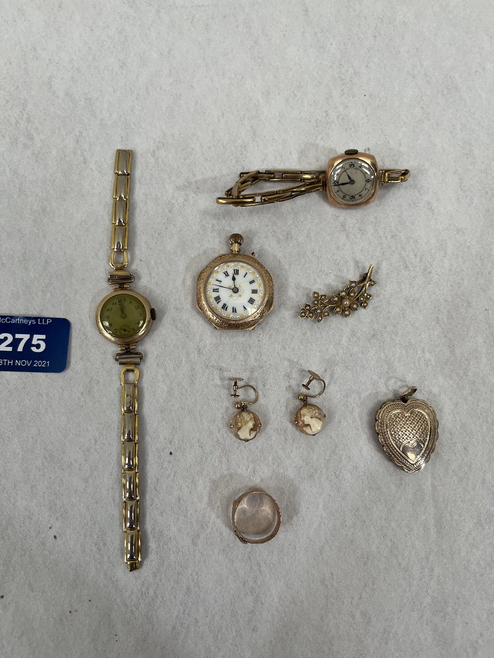 A collection of gold jewellery to include a 9ct fob watch; two gold cased lady's watches with plated