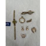 A collection of gold jewellery to include a 9ct fob watch; two gold cased lady's watches with plated