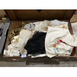 A quantity of lace and other textiles in a vintage suitcase