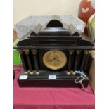 A late 19th century French mantle clock, the black slate architectural case with drum movement