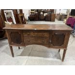 A continental walnut sideboard with a pair of cupboards flanking two drawers on square legs. 66'