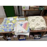 Three patchwork quilts and an embroidered bedspread