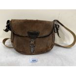 An antique canvas and leather cartridge bag. 9½' wide