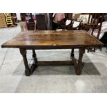 A 17th century style joined oak drawleaf table, the cleated plank top on ring turned gun barrel