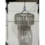 An early 20th century French chandelier hung with prismatic pendant lustre drops in three