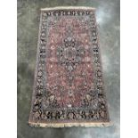 A pink ground eastern rug with centre medallion. 69' x 36'