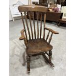 A Victorian lath back rocking chair with elm seat