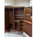 An Edwardian mahogany 'Compactom' gentleman's wardrobe with typically fitted interior, enclosed by a