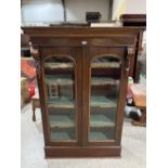 A Victorian mahogany bookcase, enclosed by a pair of arch glazed doors. 36'w x 60'h