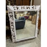 A painted carved wood wall mirror. 44½' x 36'