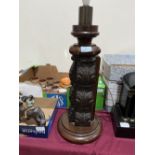 A carved mahogany and oak lamp base