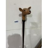A hazel walking stick, the pommel hand carved as a fawn with glass eyes. 51' long