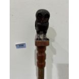 A hazel walking stick, the pommel hand carved as an owl with glass eyes. 53' long