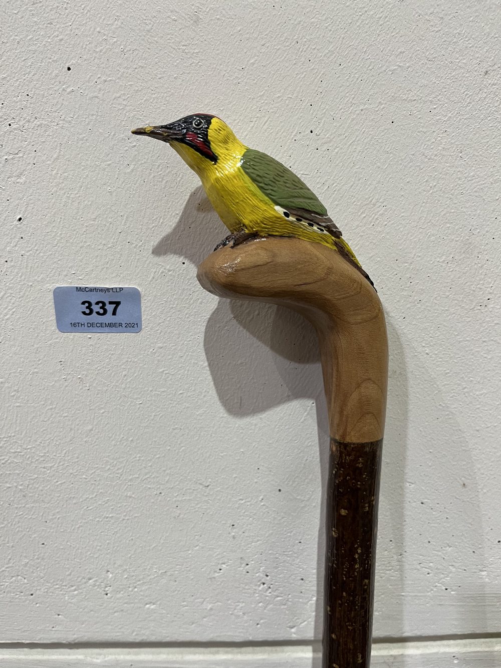 A hazel walking stick, the pommel carved as a woodpecker. 51' long