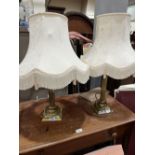 A pair of brass table lamps. (This lot subject to VAT on the hammer price)