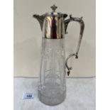 A cut glass claret jug of conical form, with plated mounts, lid and scrolled handle. 11¼' high