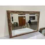 A floral framed wall mirror with bevelled plate. 25' x 35'