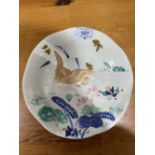 A Chinese plate painted with lilies and gilded bird. 10' diam.