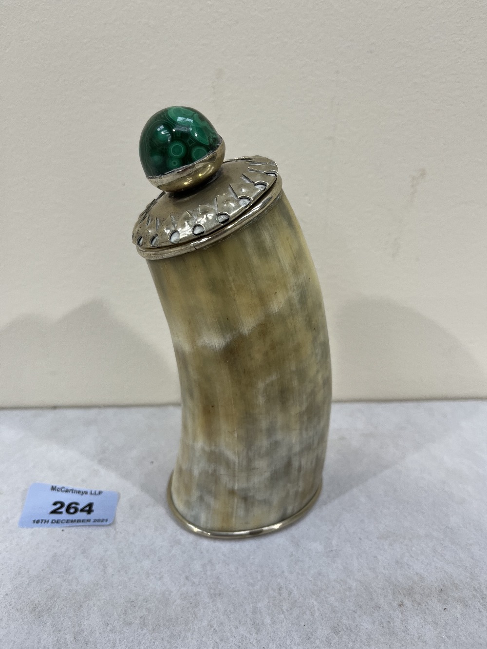 A horn and white metal mounted table snuffbox, the cover malachite cabochon knop. 6¾' high