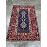 An eastern red ground rug. 77' x 49'