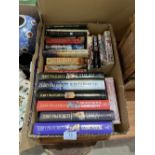A box of books by Terry Pratchett