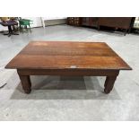 An oak low table on square legs with bun feet. 43' long