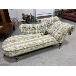 A Victorian chaise-longue with shaped button back and arm. Rear leg detached