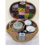 A Chinese teapot and a pair of tea bowls in basket weave case