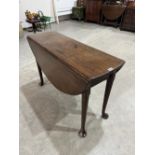 A 19th century mahogany dropleaf table on turned legs with pad feet. 43' feet. Drawer lacking