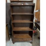 A mahogany waterfall open bookcase of four shelves over a pair of base drawers. 30'w x 59½'h. Of