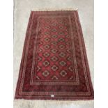 A red ground eastern rug. 77' x 44'