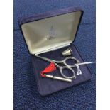 A SILVER THREE PIECE SEWING SET